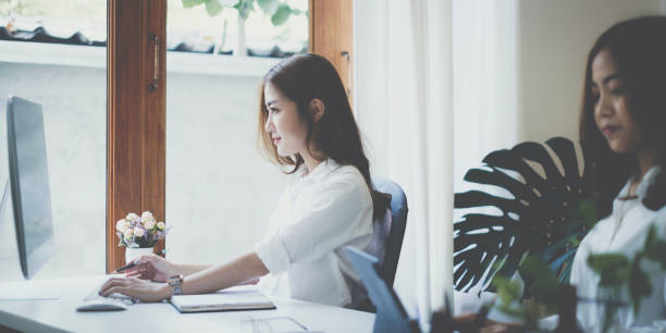 istock Asian business woman or accountant using computer desktop talk to colleagues for briefing business plan in video call. finance fund investment concept. 1367291310