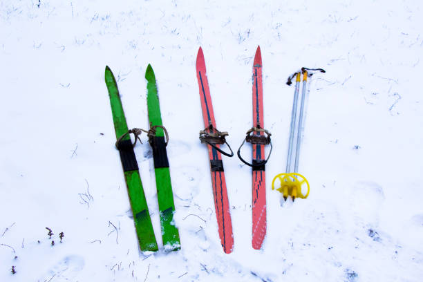 istock Old Soviet skis with poles lie in the snow 1367291717