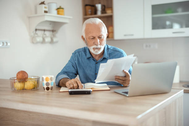 istock Senior Man Work With Financial Papers at Home 1367292552
