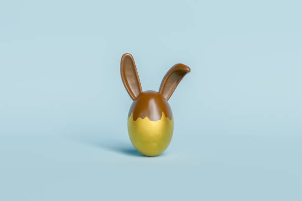 uovo di pasqua dorato con orecchie da coniglietto al cioccolato - easter rabbit easter bunny easter egg foto e immagini stock