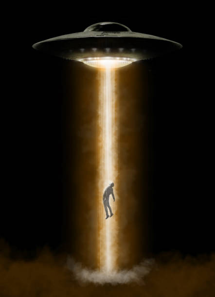 istock Man being abducted by UFO 1367292825