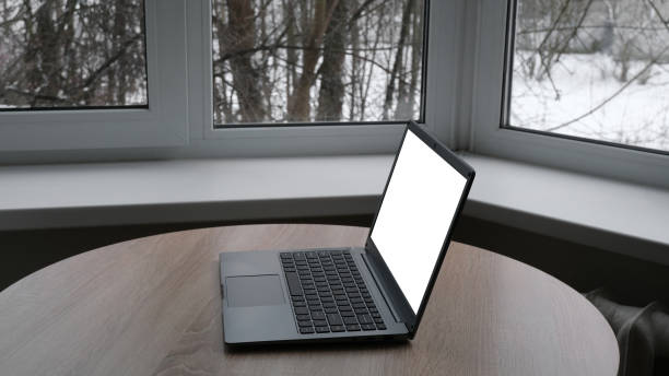 istock Open laptop on the table by the window 1367292859