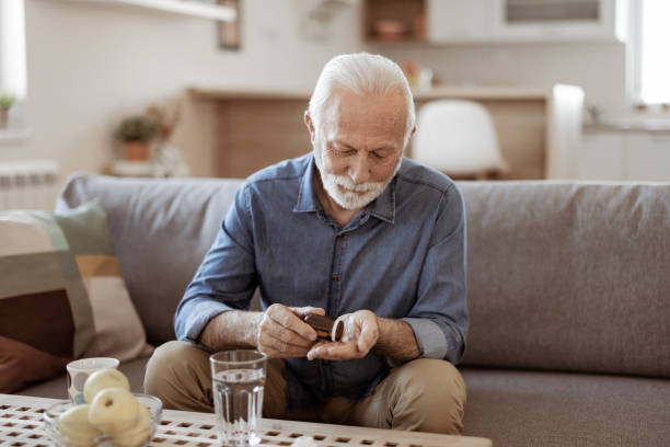 istock Senior Male Taking Pills 1367293146