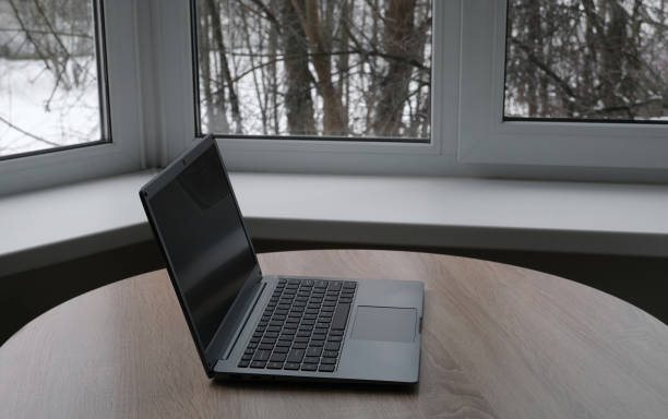 istock Open laptop on the table by the window 1367294116