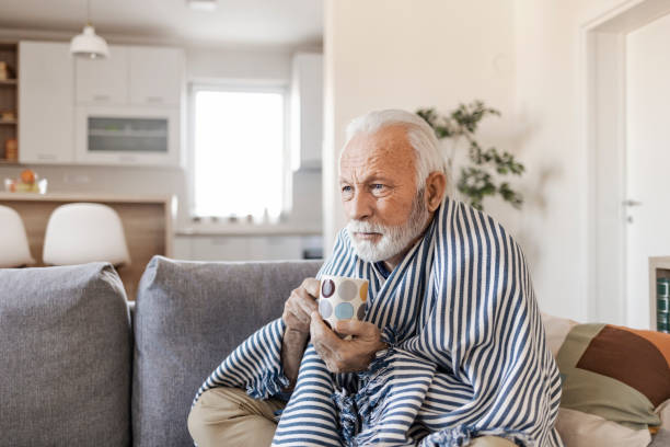 istock Sick Senior Man With Fever Wrapped in Warm Blanket 1367294225