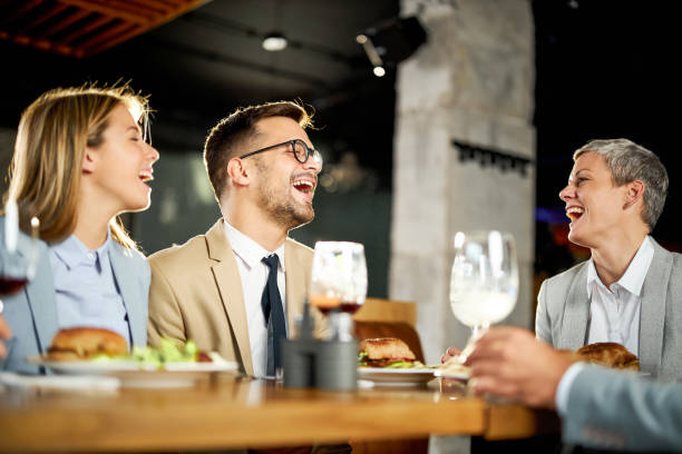 istock Cheerful business colleagues talking on a lunch in a restaurant. 1367294261