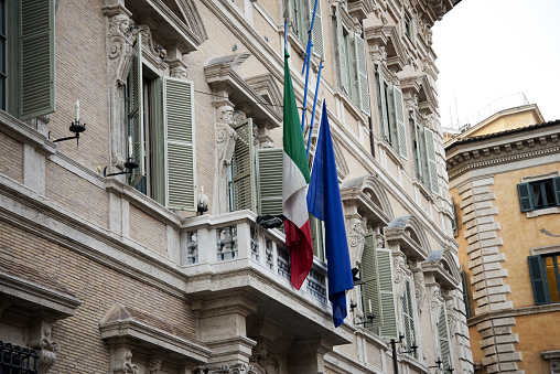 Italian and European Union flag on government building. Rome, Italy.