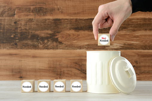 Human's hand putting wooden block with 