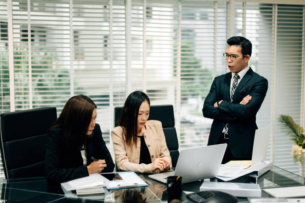 an asian manager is insulting his colleague in conference room - rudeness manager emotional stress asian ethnicity imagens e fotografias de stock