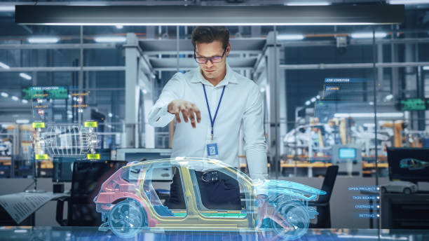 istock Sustainable Industrial Design: Portrait of Modern Automotive Engineer Using Augmented Reality to Construct 3D Hologram Model of High-Tech Electric Car. Automated Vehicle Manufacturing Facility 1367303231