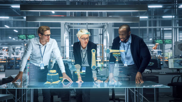 istock Industry 4.0 High-Tech Factory: Diverse Team of Robotics Engineers Working on Robot Arm Design, Using Augmented Reality Hologram to Manipulate 3D Model by Gestures. Engineering with Digital Technology 1367303314