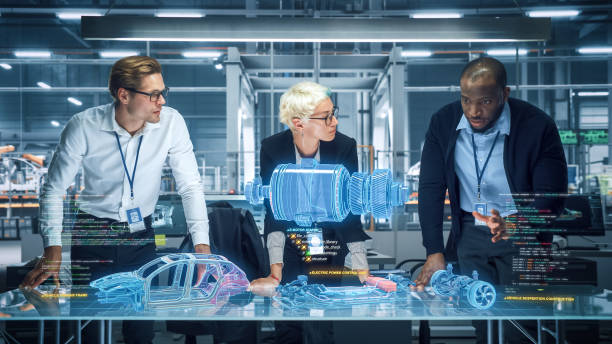 istock Green Energy Car Design: Diverse Team of Automotive Enginers Using Augmented Reality Hologram to Construct 3D Model of High-Tech Electric Vehicle Optimizing Engine. Automated Robot Arm Manufacturing 1367303363