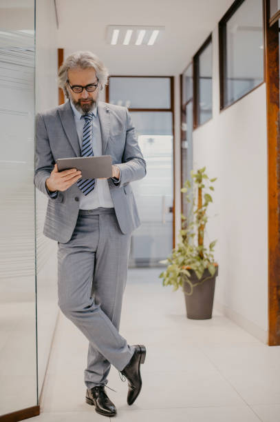 istock Successful senior businessman standing in office 1367303695