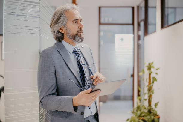 istock Successful senior businessman standing in office 1367303802