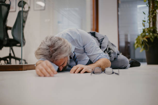 istock White haired senior businessman having heart attack in office 1367303825