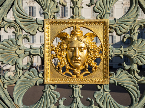 Turin, Piedmont, Italy - January 7, 2022: close-up of the gates (1840) with the head of Medusa of Pelagio Palagi (Italian architect and sculptor, 1775-1860) of the Royal Palace in Turin, Piedmont, Italy, Europe