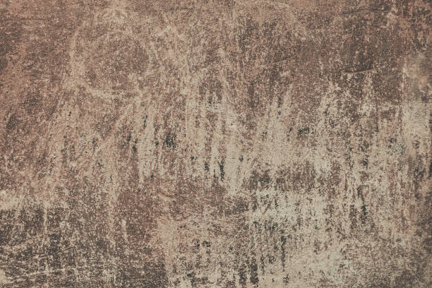 istock An old brown painted wall background. A plaster wall texture with rough scratches. 1367305243