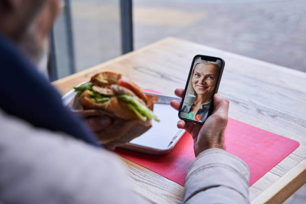 istock Senior man having call with his wife via smartphone while sitting at the table 1367306606