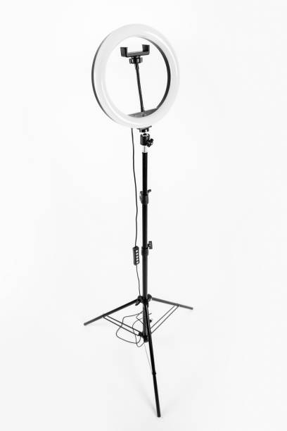 istock LED ring lamp on a high tripod. White background. 1367307463
