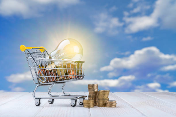 istock Light bulb and coins and in a shopping cart 1367307606