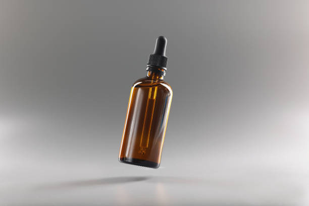istock Brown bottle with a pipette on a gray background 1367309233