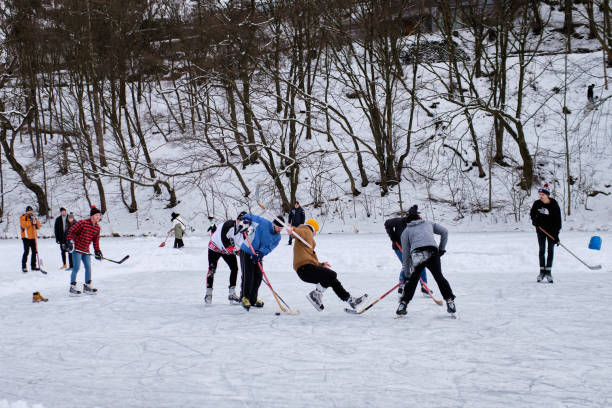 Amateur ice hokey game, Mnisek pod Brdy, Czech republic, 16 January 2021 Shot on a frozen pond below  Mnisek pod Brdy Chateau, a small village close to Prague, where local group of boys gathered to enjoy an ice hokey game during winter afternoon. walking point of view stock pictures, royalty-free photos & images