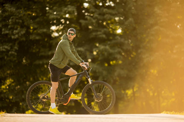 istock Young man riding ebike in nature 1367312703