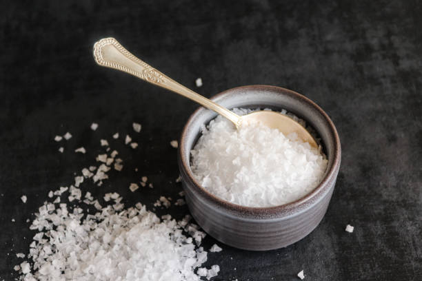 istock Flake sea salt in a bowl on dark background 1367312907