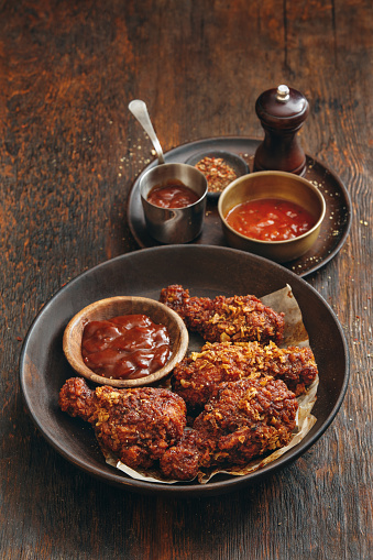 Southern BBQ Chicken. Close-up composition on dark wooden background.