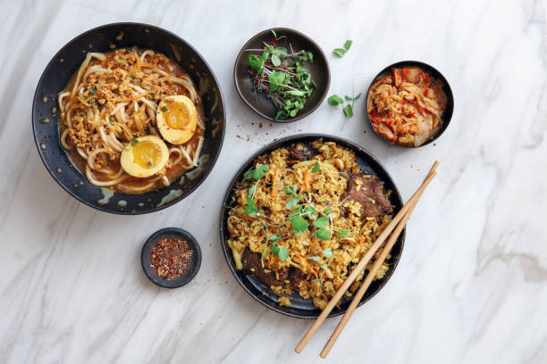 Korean Food Korean-style Curry Beef Fried Rice. Dan Dan Noodles (Tantanmen Ramen or Tan Tan Noodles). Flat lay top-down composition on marble background. Kimchi stock pictures, royalty-free photos & images