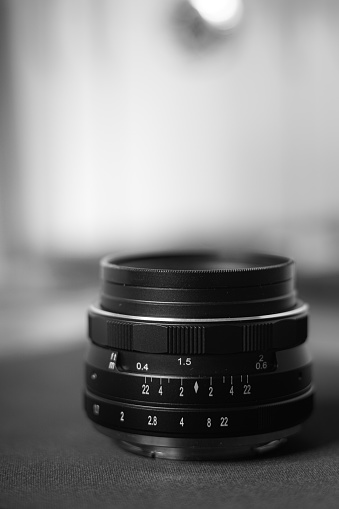 A photo that depicts the details of a classic lens with a black and white theme