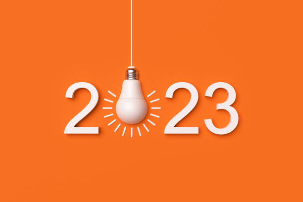 istock 2023 and white light bulb on orange background. 1367316527