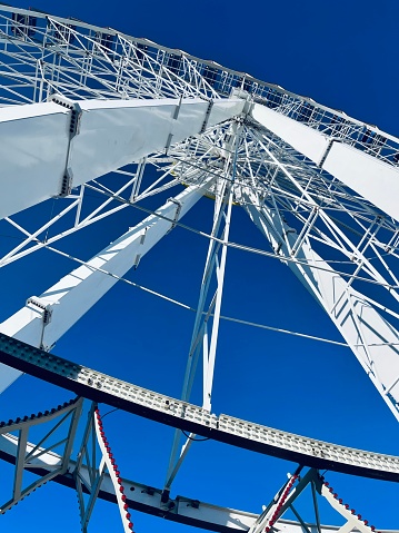 Abstract parts of a large ferris wheel on blue sky