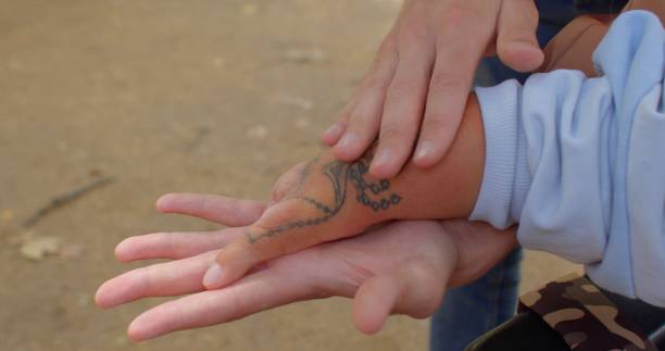 istock Social worker doing massage to disabled person. Congenital amputations. Close up 1367321525
