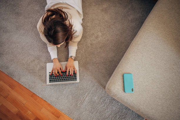 istock Woman using laptop at home 1367326299