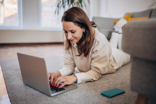 istock Woman using laptop at home 1367326308