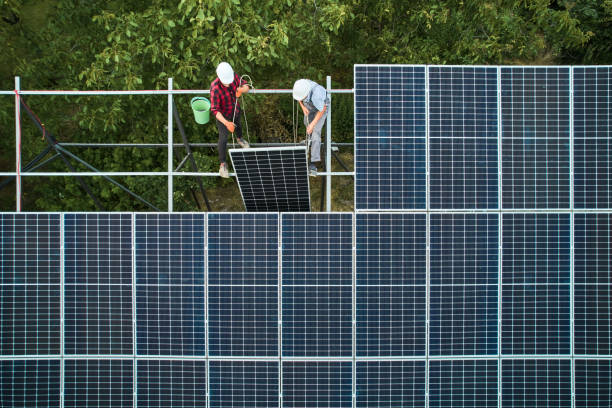 istock Aerial view of workers installing solar panels 1367326978