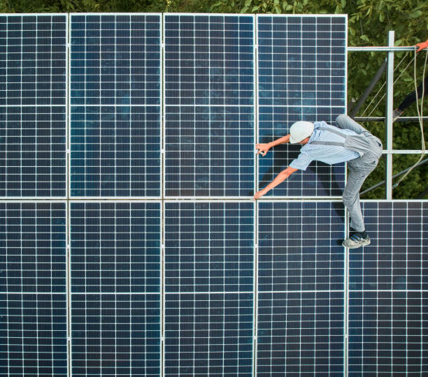 istock Arial view of male worker installing photovoltaic solar panel. 1367327004