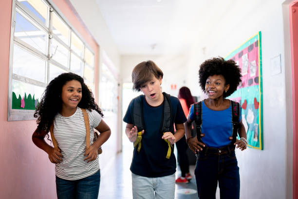 istock Kids talking and walking in the corridor at school 1367328032