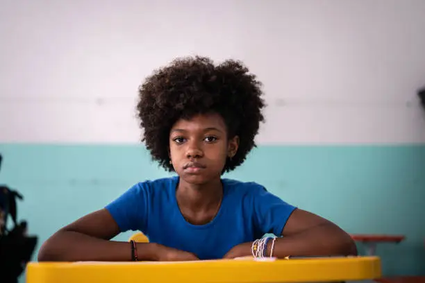 Photo of Portrait of a serious girl in the classroom