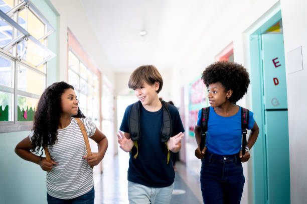istock Kids talking and walking in the corridor at school 1367328093