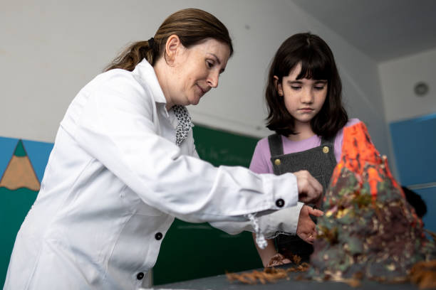 istock Teacher teaching about volcano to a student in the classroom 1367328428