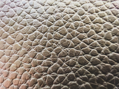 A macro image of a light brown leather.