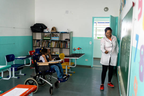 istock Teacher talking with boy with special needs in the classroom 1367329609