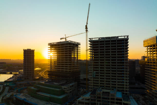 istock Aerial view construction crane in a construction site at sunset 1367329853