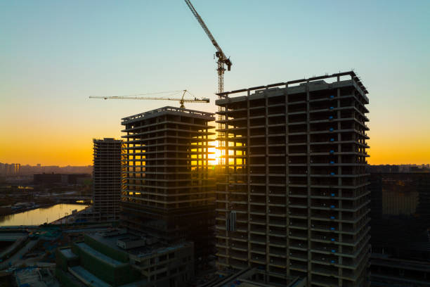 istock Aerial view construction crane in a construction site at sunset 1367329877