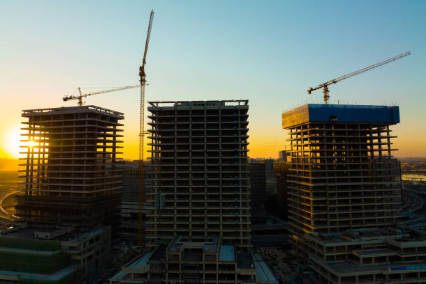 istock Aerial view construction crane in a construction site at sunset 1367329879
