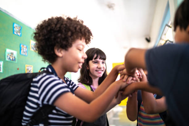 istock Kids putting their hands together in the corridor at school 1367329892
