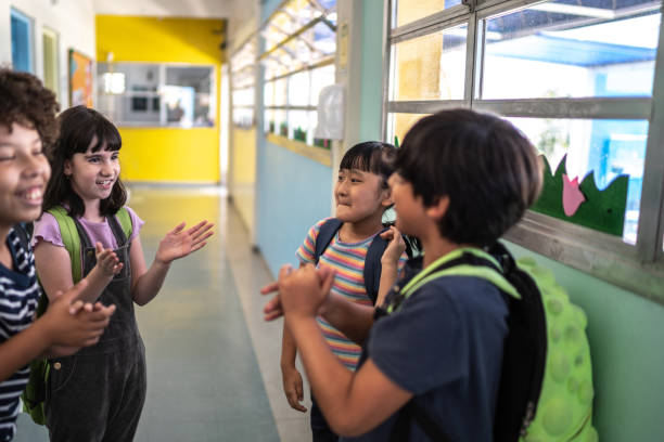 istock Kids celebrating in the corridor at school 1367329999