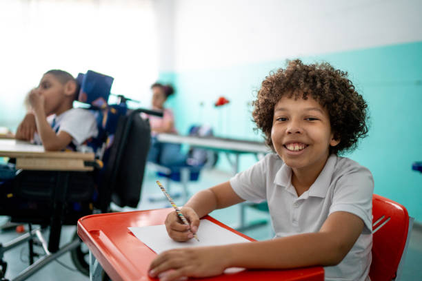 istock Portrait of a boy taking notes in the classroom 1367330037